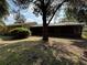 Rear view of property showcasing the screened-in lanai and spacious backyard at 3957 Bearded Oaks Ct, Sarasota, FL 34232