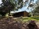 Backyard view of a well maintained home with a screened in patio at 3957 Bearded Oaks Ct, Sarasota, FL 34232