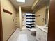 Bathroom featuring shower with blue striped curtains and tile flooring at 3957 Bearded Oaks Ct, Sarasota, FL 34232