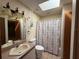 Bathroom with a shower-tub combo and decorative vanity with an off-white sink at 3957 Bearded Oaks Ct, Sarasota, FL 34232