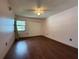 Bedroom with hardwood floors, neutral walls, a ceiling fan, and a closet with sliding doors for ample storage at 3957 Bearded Oaks Ct, Sarasota, FL 34232
