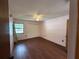 Bright bedroom featuring wood floors, a ceiling fan, and a large closet with sliding doors at 3957 Bearded Oaks Ct, Sarasota, FL 34232
