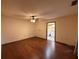 Spacious bedroom with hardwood floors, ceiling fan, and an open door to the bathroom at 3957 Bearded Oaks Ct, Sarasota, FL 34232