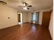Large bedroom with hard wood floors, a ceiling fan, and a window that brings in natural light at 3957 Bearded Oaks Ct, Sarasota, FL 34232