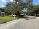 Well-kept home with a long driveway, green lawn, and mature shade trees at 3957 Bearded Oaks Ct, Sarasota, FL 34232