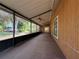 View of a spacious outdoor patio with a screened in window at 3957 Bearded Oaks Ct, Sarasota, FL 34232