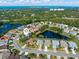 Stunning aerial view of a lakeside community featuring well-manicured lawns and mature trees at 4063 Westbourne Cir, Sarasota, FL 34238