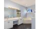 Bathroom featuring double sinks, bathtub, walk-in shower, and large mirror at 4063 Westbourne Cir, Sarasota, FL 34238