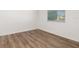 Small bedroom with hardwood floors, window with blinds, and neutral walls at 4063 Westbourne Cir, Sarasota, FL 34238