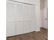 Bedroom featuring closet with sliding doors and hardwood floors at 4063 Westbourne Cir, Sarasota, FL 34238