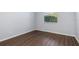 Bedroom with hardwood floors, window, and neutral walls at 4063 Westbourne Cir, Sarasota, FL 34238