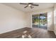 Spacious bedroom with hardwood floors and sliding glass doors to the pool at 4063 Westbourne Cir, Sarasota, FL 34238