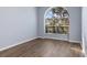 Bright bedroom features hard flooring and large arched window allowing natural light to illuminate the space at 4063 Westbourne Cir, Sarasota, FL 34238