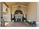 Elegant clubhouse entrance featuring stone accents, columns, and well-maintained landscaping at 4063 Westbourne Cir, Sarasota, FL 34238