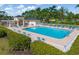 Inviting community pool area with lounge chairs, shade structures, and well-maintained landscaping at 4063 Westbourne Cir, Sarasota, FL 34238