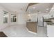 Open floor plan featuring a kitchen with granite counters, white cabinets, and adjacent living space at 4063 Westbourne Cir, Sarasota, FL 34238