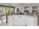 Updated kitchen featuring granite countertops, a sink, and ample white cabinetry at 4063 Westbourne Cir, Sarasota, FL 34238