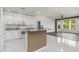 Bright kitchen featuring white cabinets, granite countertops, and an island at 4063 Westbourne Cir, Sarasota, FL 34238