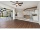Open concept living space with hardwood flooring flowing into the kitchen and lanai at 4063 Westbourne Cir, Sarasota, FL 34238