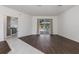 Open living room with hardwood flooring and sliding glass doors to the pool area at 4063 Westbourne Cir, Sarasota, FL 34238
