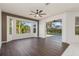 Bright living room with hardwood floors, ceiling fan, and pool view at 4063 Westbourne Cir, Sarasota, FL 34238