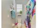 Compact bathroom featuring a toilet, a colorful shower curtain, and a small window at 4211 30Th E Ln, Bradenton, FL 34208