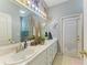 Bathroom showcasing dual sinks with ample counter space, stylish decor, and a bright window at 4211 30Th E Ln, Bradenton, FL 34208