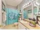 Bathroom with a blue shower curtain, fish tank, towels, and decor at 4211 30Th E Ln, Bradenton, FL 34208
