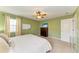 Inviting bedroom with a ceiling fan, chest of drawers, and a large window at 4211 30Th E Ln, Bradenton, FL 34208