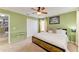 Comfortable bedroom featuring a ceiling fan, soft carpet, and a queen-size bed at 4211 30Th E Ln, Bradenton, FL 34208