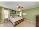 Bedroom with a king-size bed, a ceiling fan, and natural light from large windows at 4211 30Th E Ln, Bradenton, FL 34208