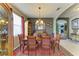 Dining room featuring a large window, chandelier, and access to the living room and game room at 4211 30Th E Ln, Bradenton, FL 34208
