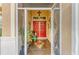 The bright, covered front porch features double doors, vibrant flowers, decorative tile, and a decorative screen door at 4211 30Th E Ln, Bradenton, FL 34208