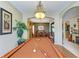 Game room boasts billiard table, chandelier lighting, and access to dining room, kitchen, and entryway at 4211 30Th E Ln, Bradenton, FL 34208