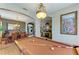 Game room showcases billiard table, chandelier, and open access to the dining room and living room at 4211 30Th E Ln, Bradenton, FL 34208