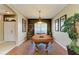 Bright game room with a billiard table, chandelier lighting, and natural light from the front window at 4211 30Th E Ln, Bradenton, FL 34208
