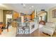 Open-concept kitchen featuring wood cabinets, breakfast bar, and views of the dining room and living room at 4211 30Th E Ln, Bradenton, FL 34208