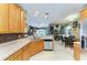 Well-lit kitchen with stainless steel appliances and light wood cabinets and tile backsplash at 4211 30Th E Ln, Bradenton, FL 34208