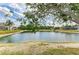 Backyard view showcasing a serene lake setting, enhancing the property's appeal at 4211 30Th E Ln, Bradenton, FL 34208