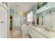Bright bathroom boasting dual sinks, soaking tub with shower, linen closet, and light blue walls at 4211 30Th E Ln, Bradenton, FL 34208