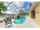 Inviting pool area with a screened enclosure, comfortable seating, and a beautiful waterfront view at 4211 30Th E Ln, Bradenton, FL 34208