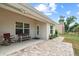 Relaxing back patio with seating, brick pavers, and views of the outdoor space at 4466 Manila Ave, North Port, FL 34288
