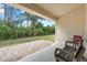 Charming covered patio offering views of a green backyard and mature trees at 4466 Manila Ave, North Port, FL 34288