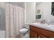 Well-lit bathroom featuring a floral shower curtain, toilet, and vanity with granite counters at 4466 Manila Ave, North Port, FL 34288