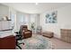 Well-lit room with a bay window, comfortable seating, area rug and an accent painting at 4466 Manila Ave, North Port, FL 34288