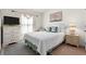 Comfortable bedroom with a large window, side tables, and carpeted floors at 4466 Manila Ave, North Port, FL 34288