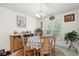 Charming dining room with chandelier, table and chairs, with a view to the outdoors at 4466 Manila Ave, North Port, FL 34288