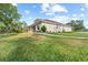 Beautiful single-story home with a well-maintained lawn and a paved walkway at 4466 Manila Ave, North Port, FL 34288
