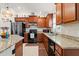 Spacious kitchen with stainless steel appliances, granite countertops, and wooden cabinets at 4466 Manila Ave, North Port, FL 34288
