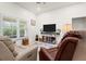 Comfortable living room with large window and neutral decor, perfect for relaxing and entertaining at 4466 Manila Ave, North Port, FL 34288